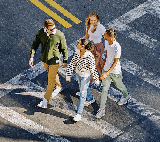 A group of friends crossing a street