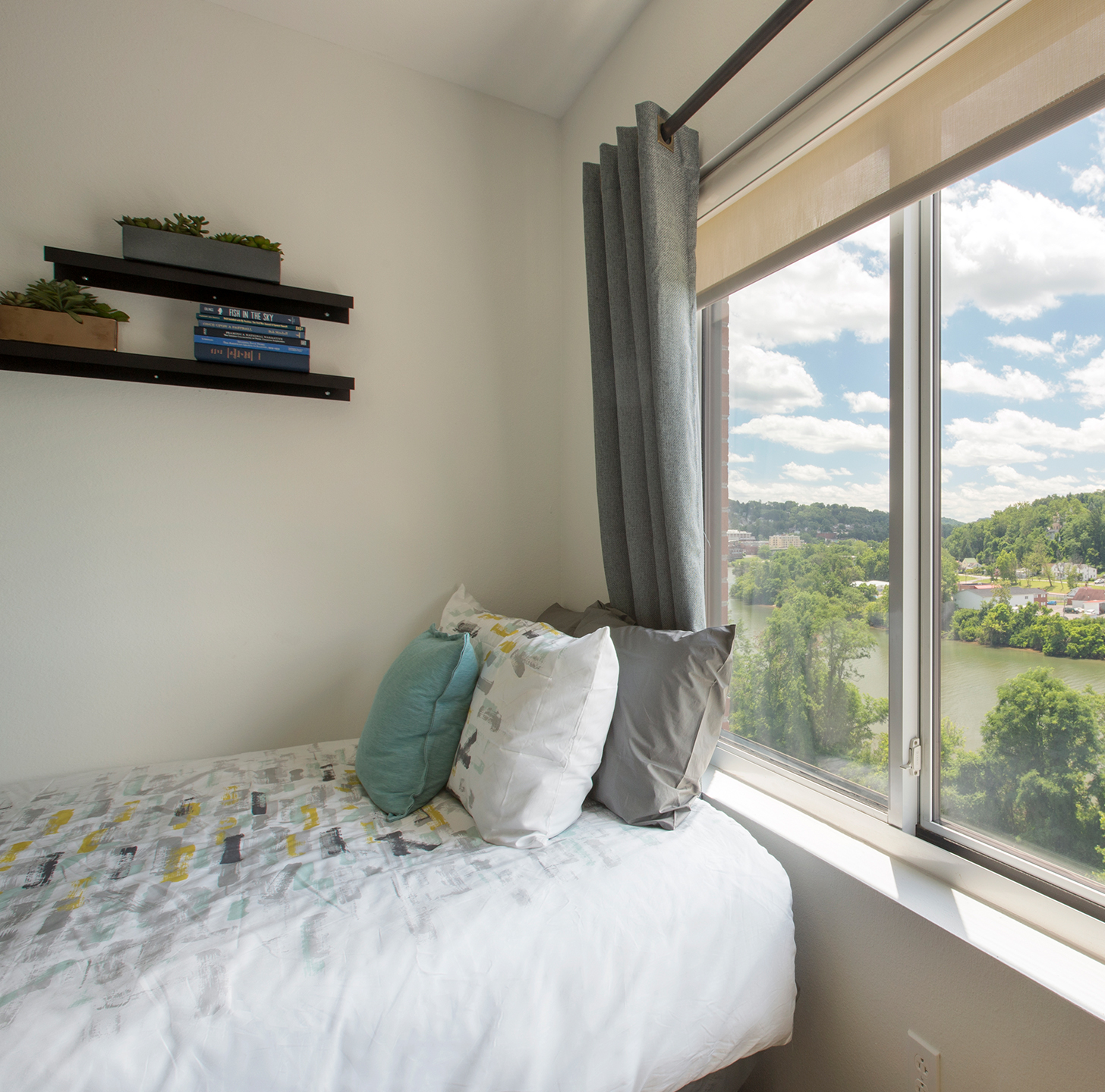 A bed next to a window