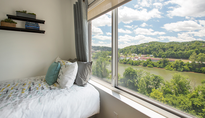 A bed next to a window