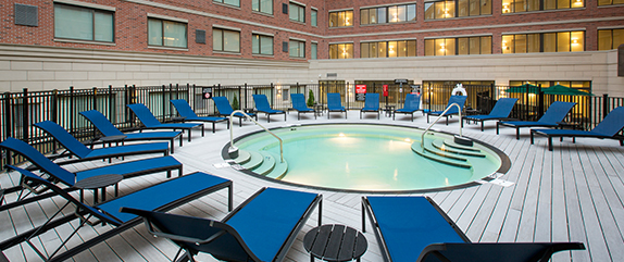 A circular swimming pool with poolside seating