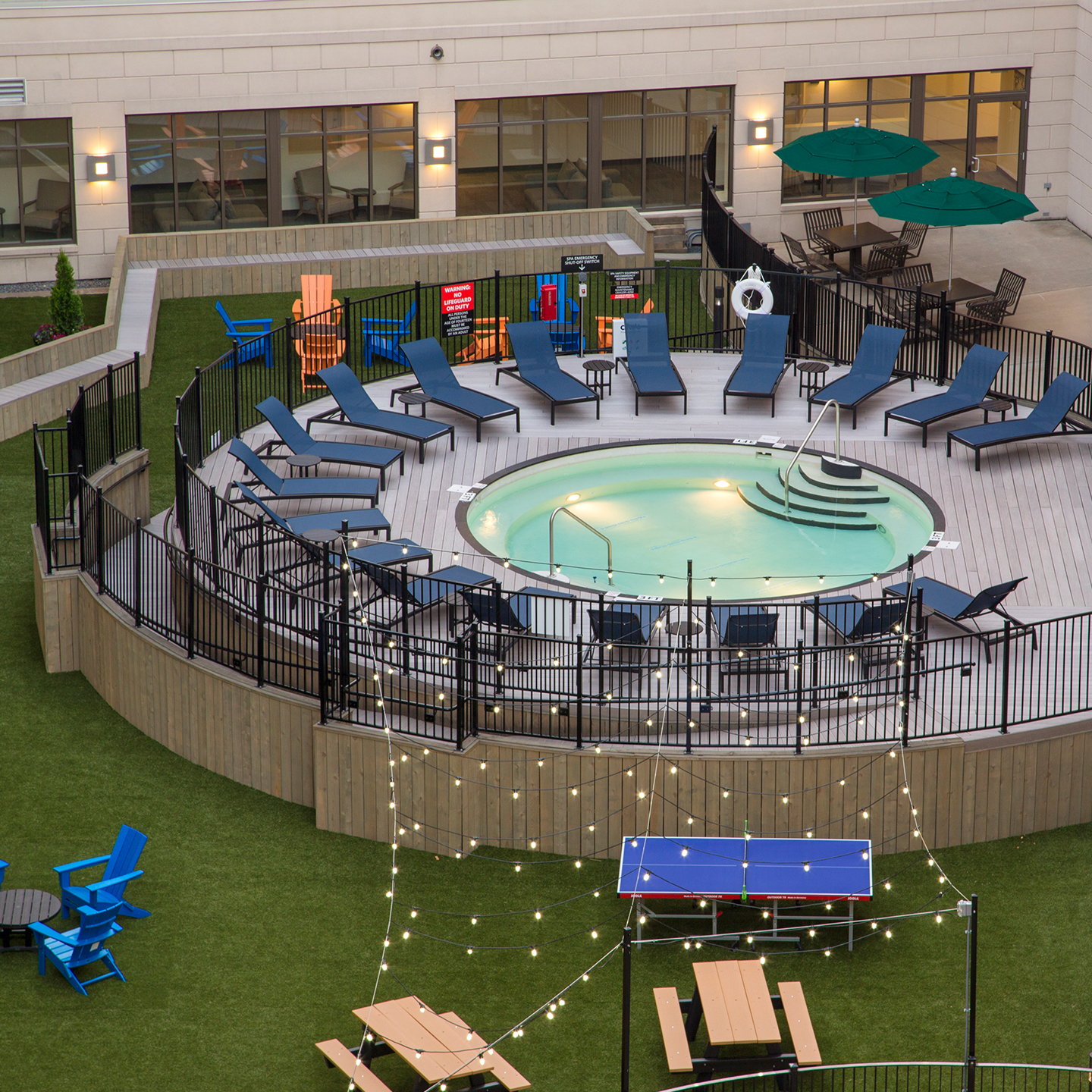 A circular swimming pool with poolside seating