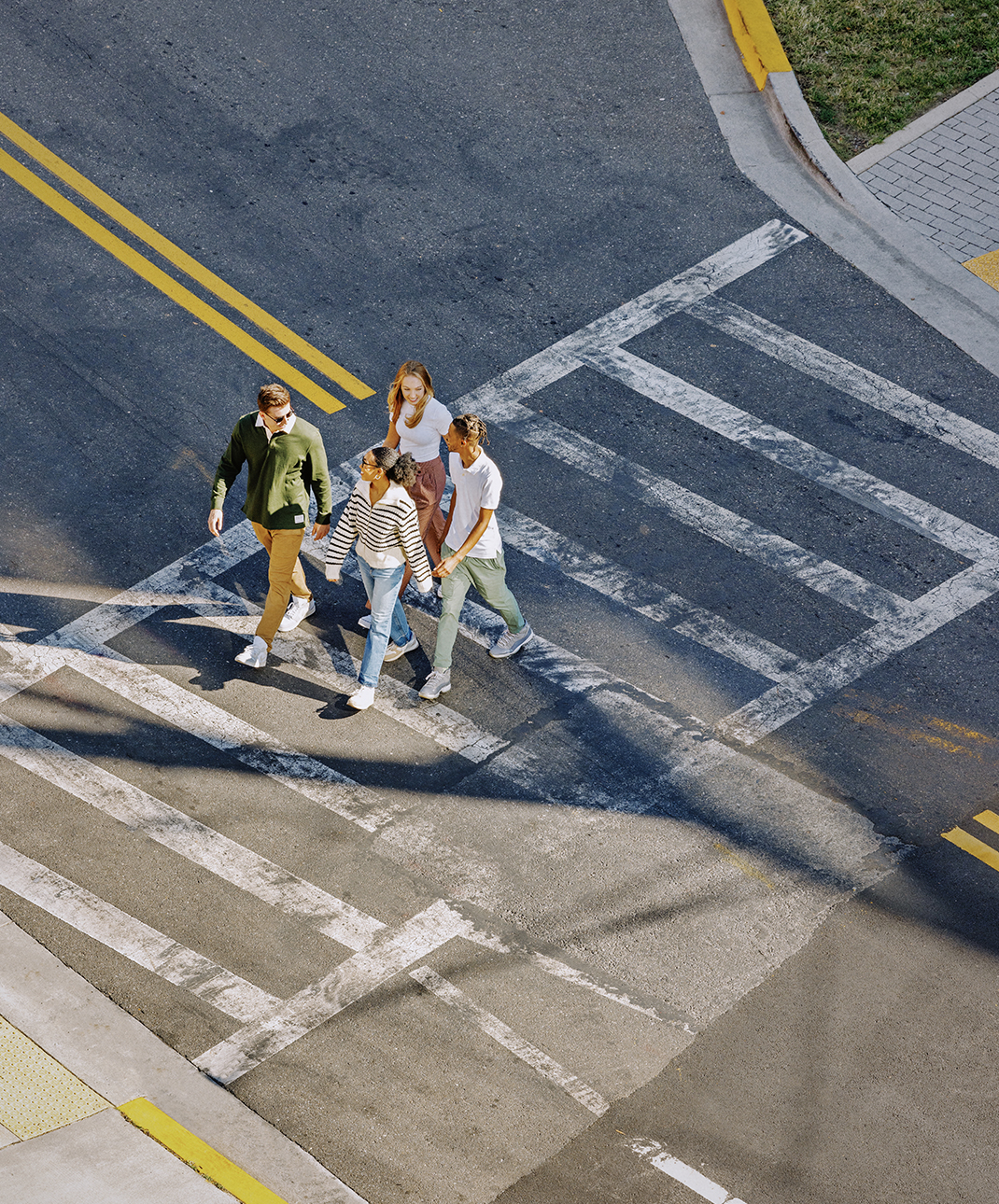 A group of friends crossing a street