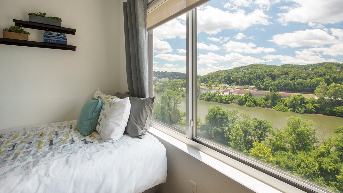 A bed next to a window