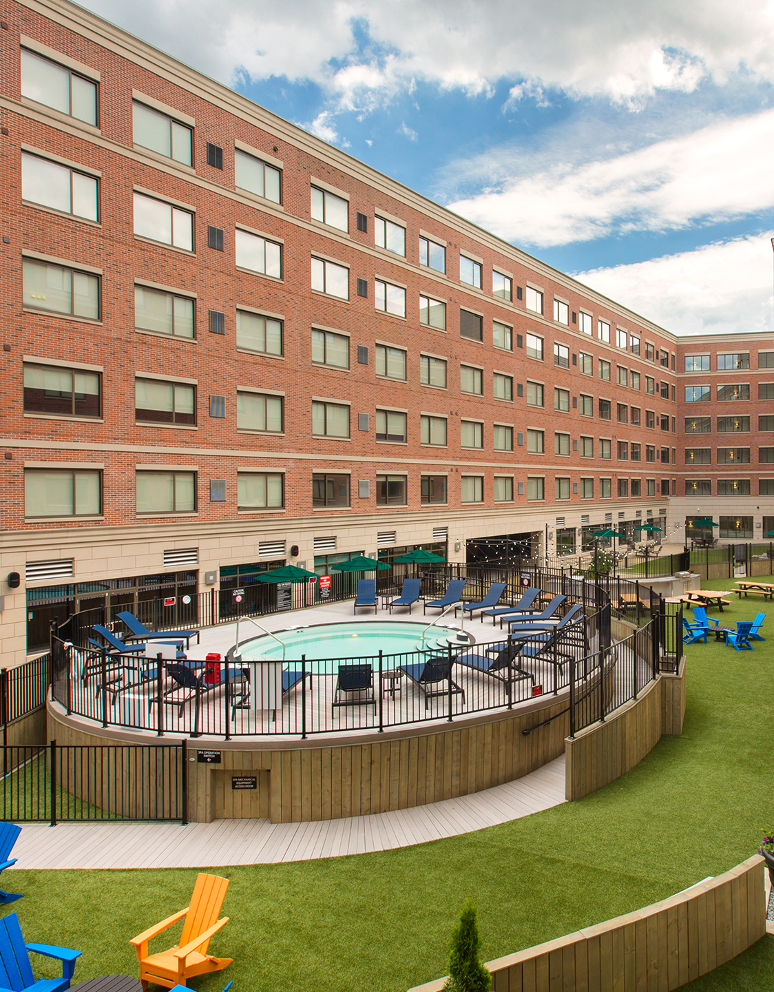 A circular swimming pool with poolside seating