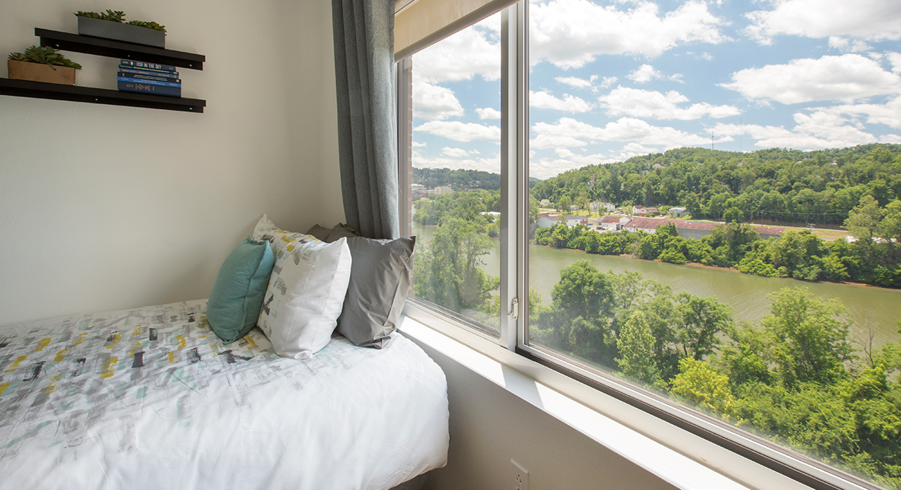A bed next to a window