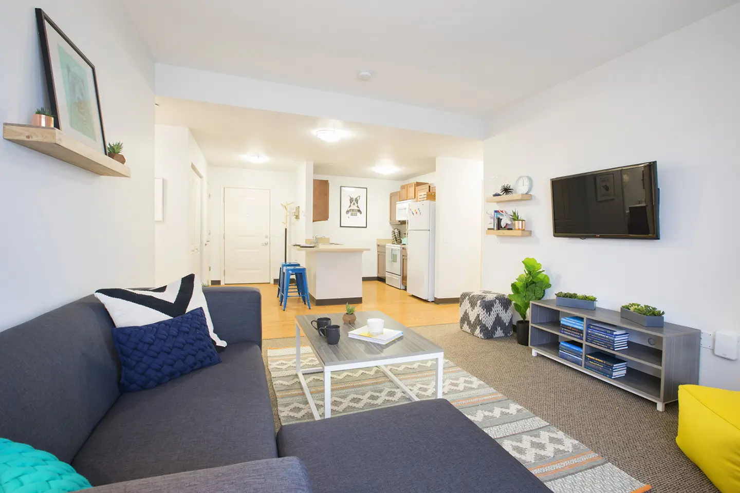 Couch, flat screen TV, coffee table, and other furniture in a State on Campus Morgantown unit