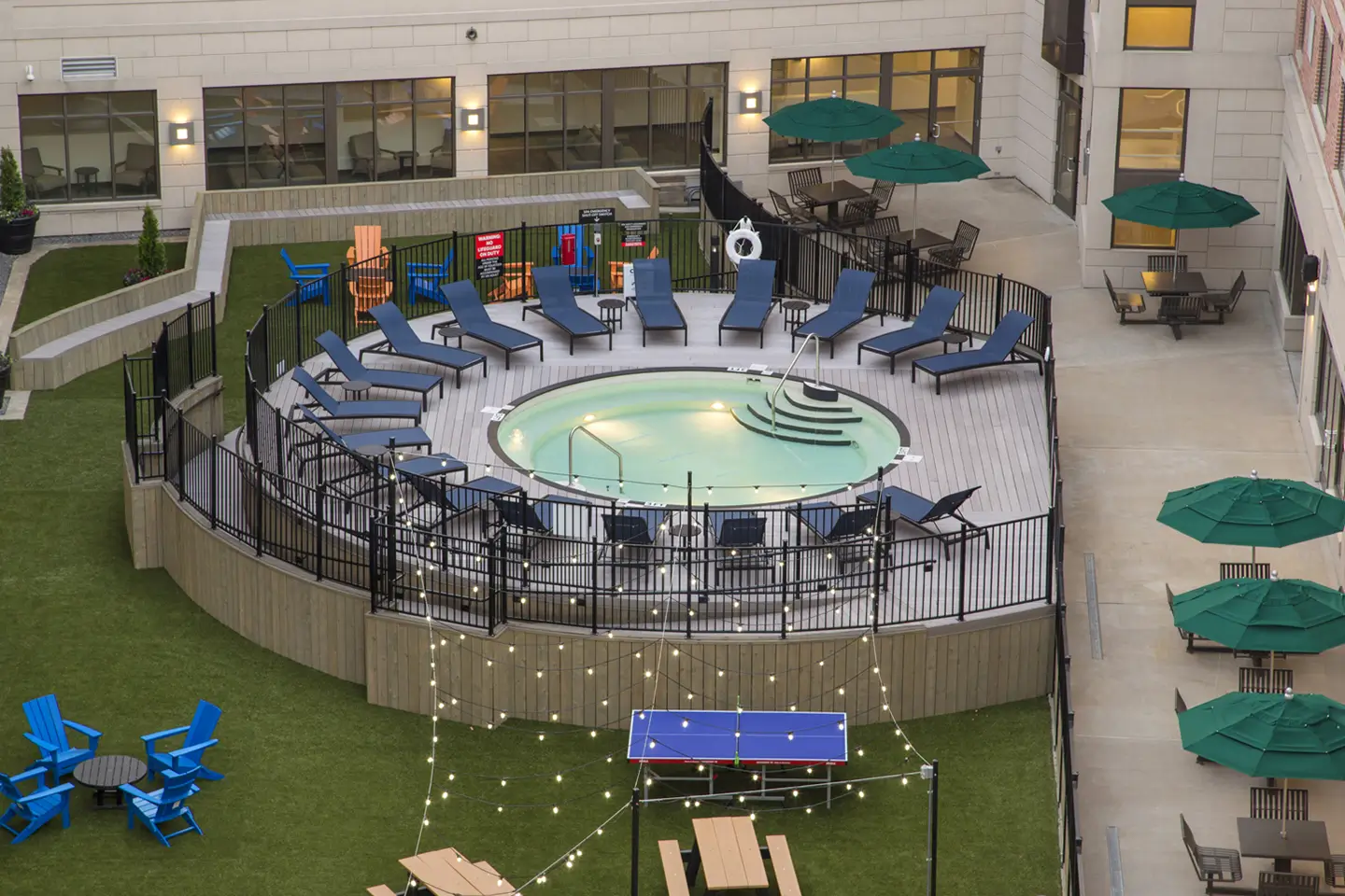 Courtyard with chairs and pool at State on Campus Morgantown