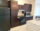 A kitchen with brown cabinets