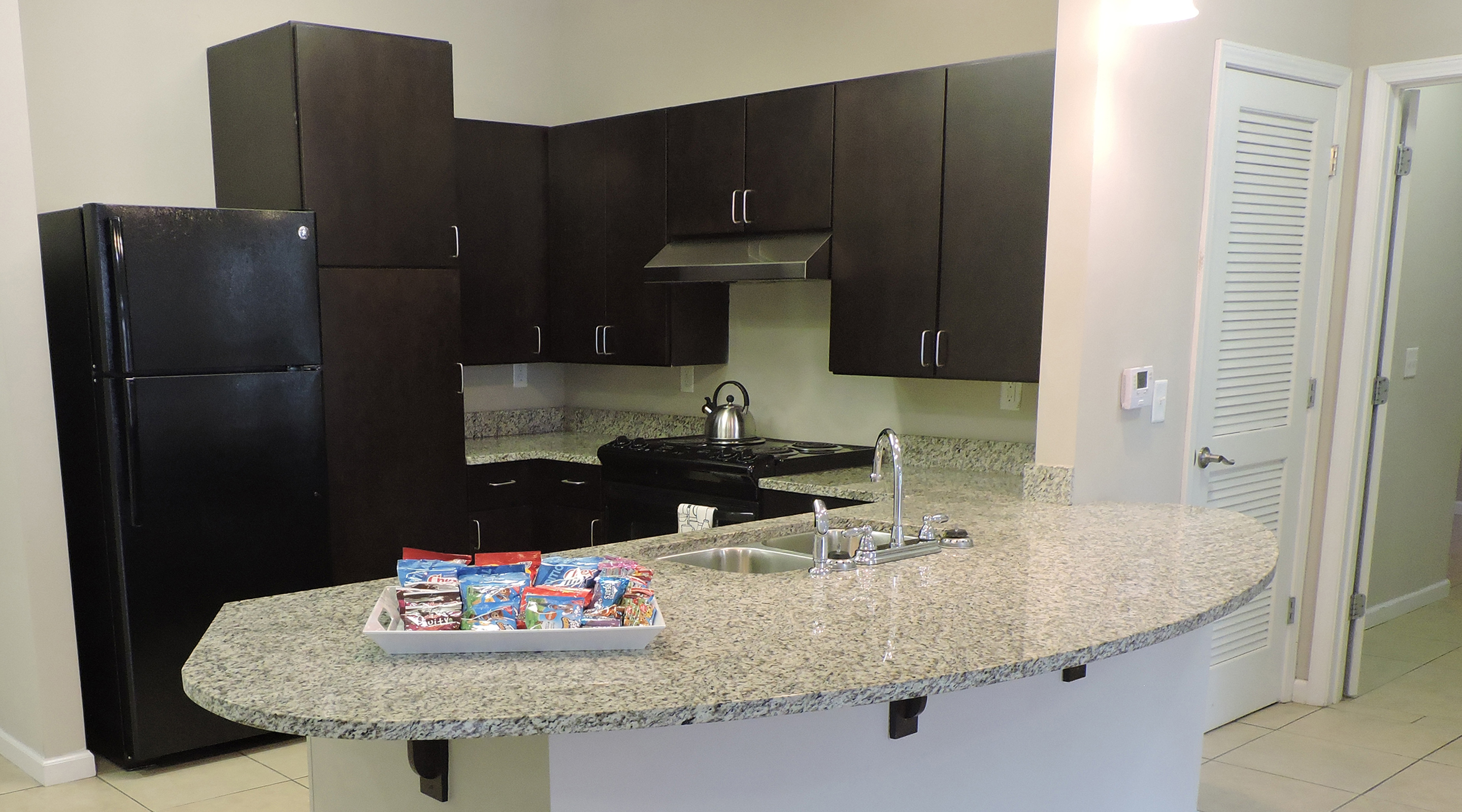 A kitchen with brown cabinets