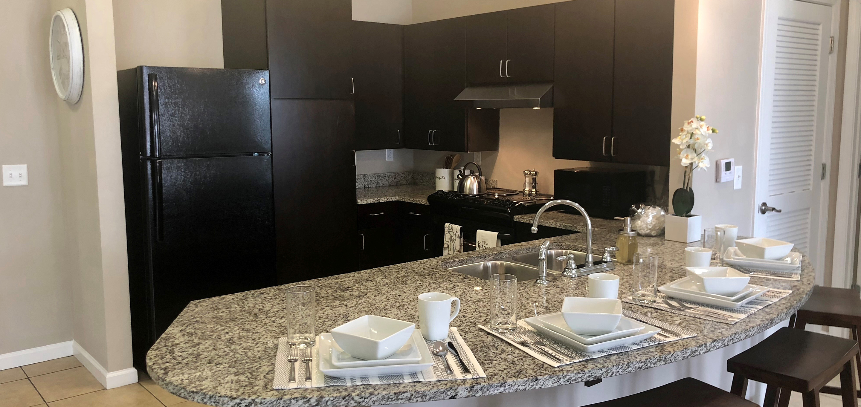 A kitchen with brown cabinets