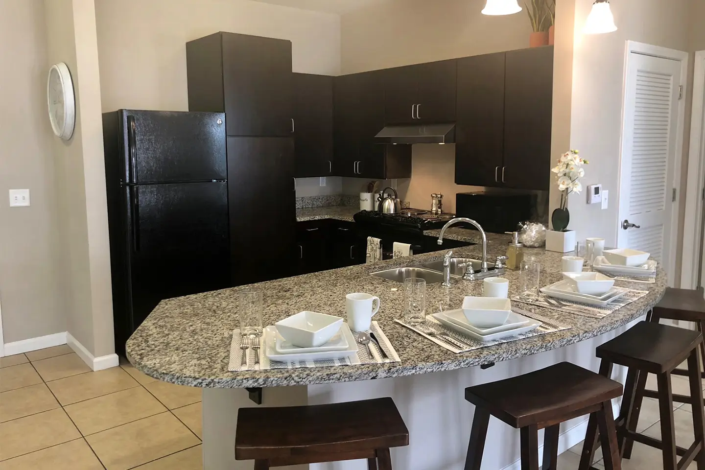 Kitchen with barstool seating and granite countertops